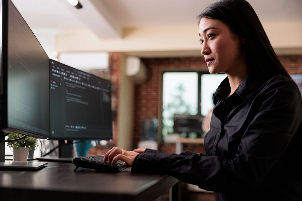 A woman working on a computer with data